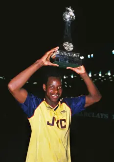 Michael Thomas celebrates with the league trophy after winning the 1988 / 9 title