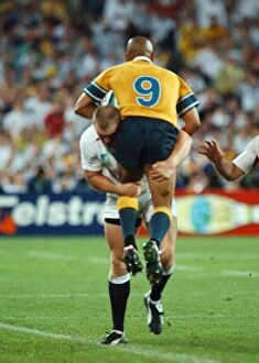 Images Dated 22nd November 2003: Mike Tindall dump tackles George Gregan during the 2003 World Cup Final