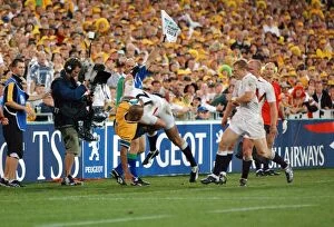 Images Dated 22nd November 2003: Mike Tindall dump tackles George Gregan off the field during the 2003 World Cup Final