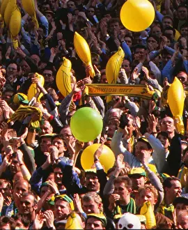 Norwich City fans cheer on their team with balloons and canary inflatables during the 1989 FA Cup