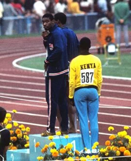 1972 Munich Olympics Collection: Olympic 400m winner Vince Matthews shows his disinterest in the medal ceremony in Munich in 1972