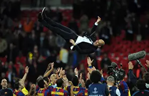 Pep Guardiola is thrown in the air by his team at Wembley after victory in the Champions League Final