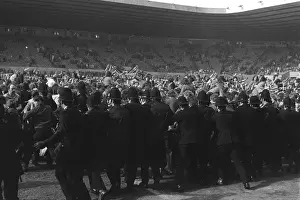 Police try to stop Manchester United fans invading the Old Trafford pitch after Denis Laws goal relegates the club in 1974