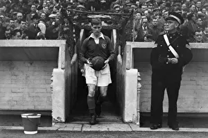Portsmouth captain Jimmy Dickinson leads his side out at Fratton Park in 1955