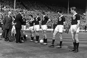 Prince Phillip shakes hands with Denis Law during the 1961 Home Championship