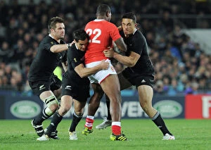 Images Dated 9th September 2011: Richie McCaw, Dan Carter, and Sonny Bill Williams make a tackle at the 2011 Rugby World Cup