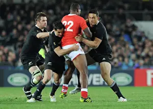 Richie McCaw, Dan Carter, and Sonny Bill Williams make a tackle at the 2011 Rugby World Cup