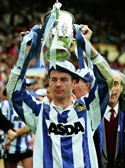 Sheffield Wednesday goalscorer John Sheridan holds aloft the League Cup trophy in 1991