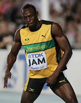 Images Dated 4th September 2011: Usain Bolt celebrates anchoring Jamaica to World Championship relay gold & a new WR