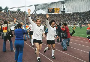 West Germanys Hans-Georg Schwarzenbeck and Gerd Muller go on a lap of honour after winning the 1974 World Cup