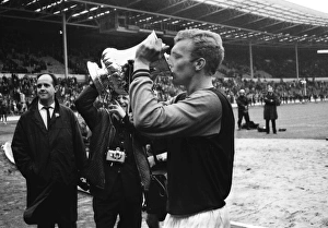 West Ham captain Bobby Moore drinks out of the FA Cup after victory in 1964