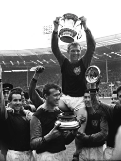 West Ham captain Bobby Moore lifts the FA Cup trophy in 1964